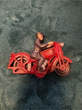 vintage 1930s red cast iron Hubley toy motorcycle with a police rider
